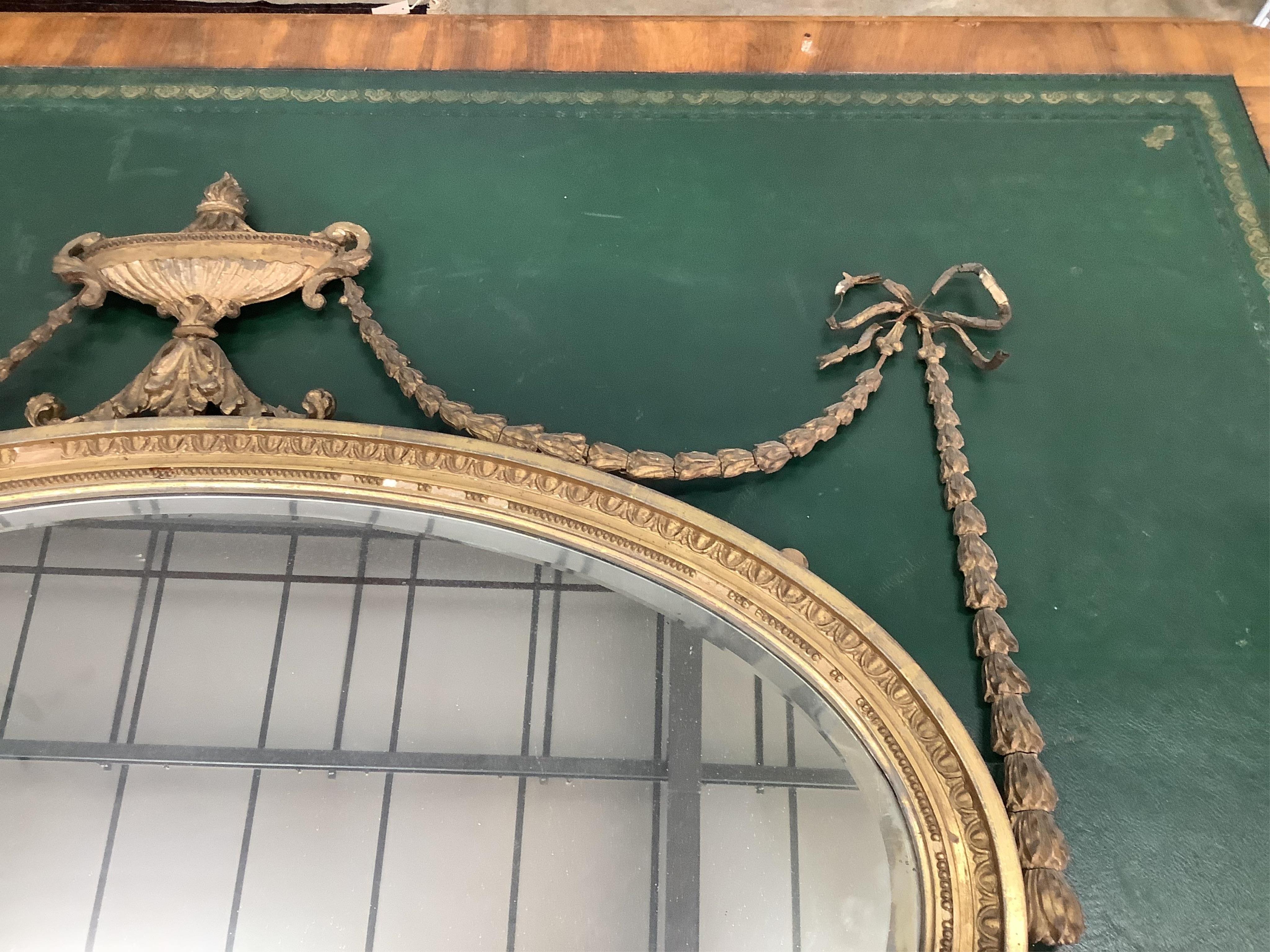 An early 20th century Adam Revival giltwood wall mirror, width 108cm, height 87cm. Condition - numerous losses